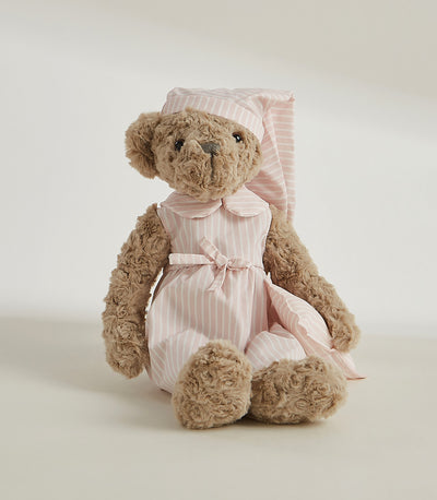 Plush teddy bear in pink striped dress with white collar and matching sleep cap