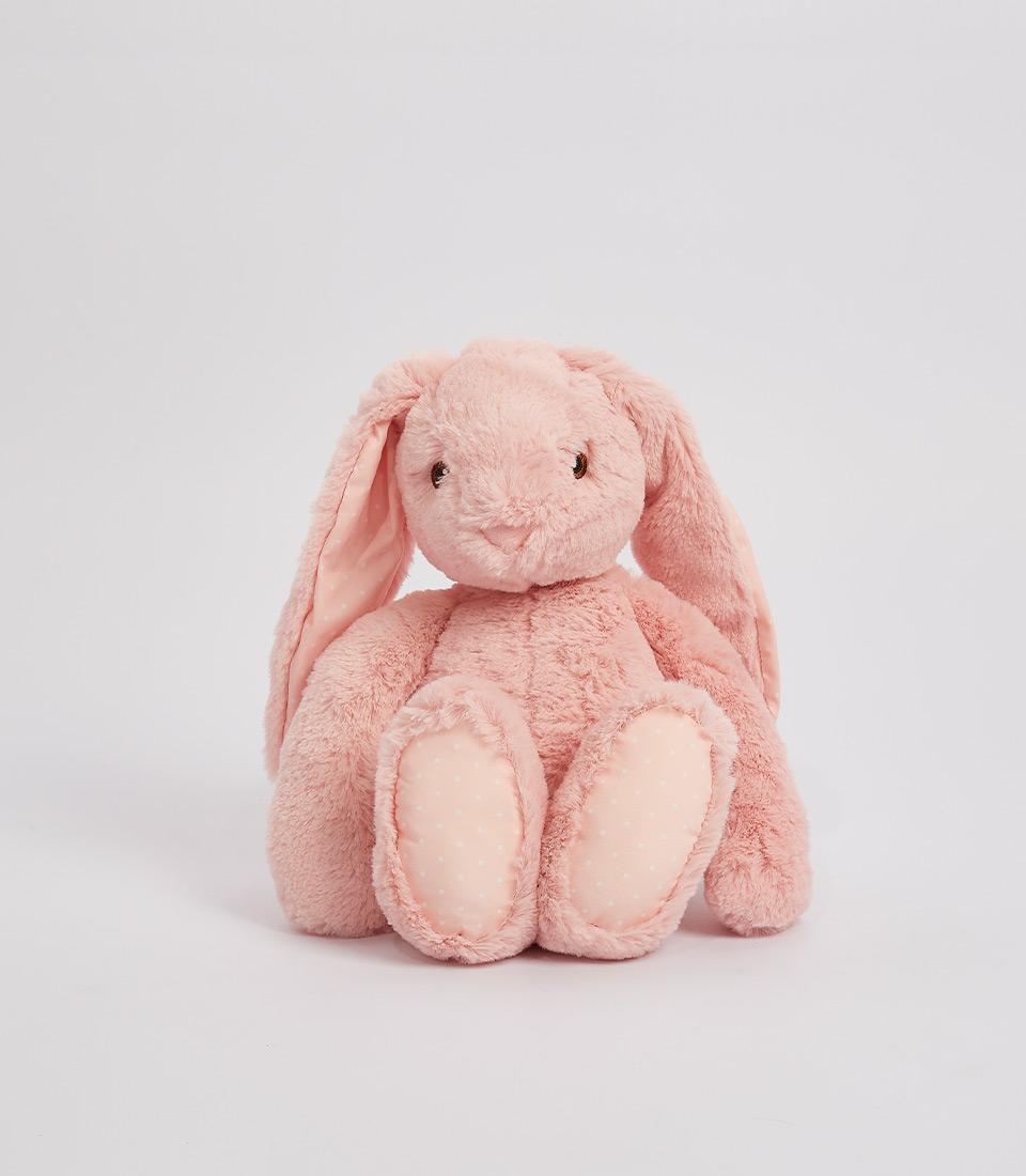 Soft pink plush bunny with floppy ears and polka dot paw pads, perfect cuddly toy for babies and kids