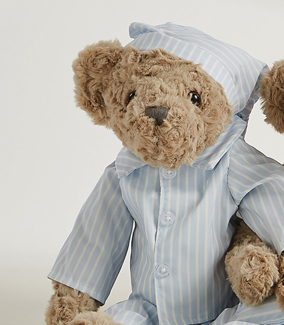 Soft plush teddy bear in blue striped pajamas and nightcap for kids