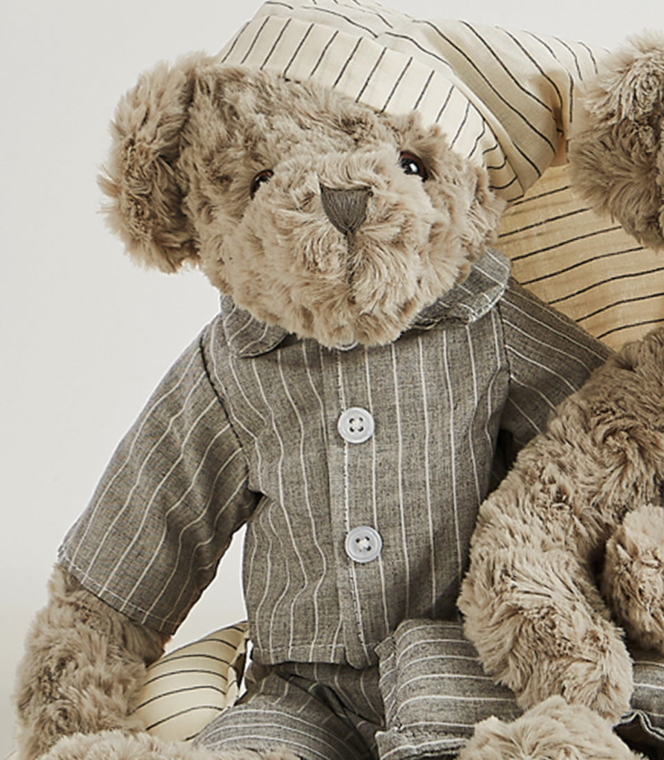 Light brown plush teddy bear in grey pinstriped pajamas and sleep cap, perfect for bedtime gifting