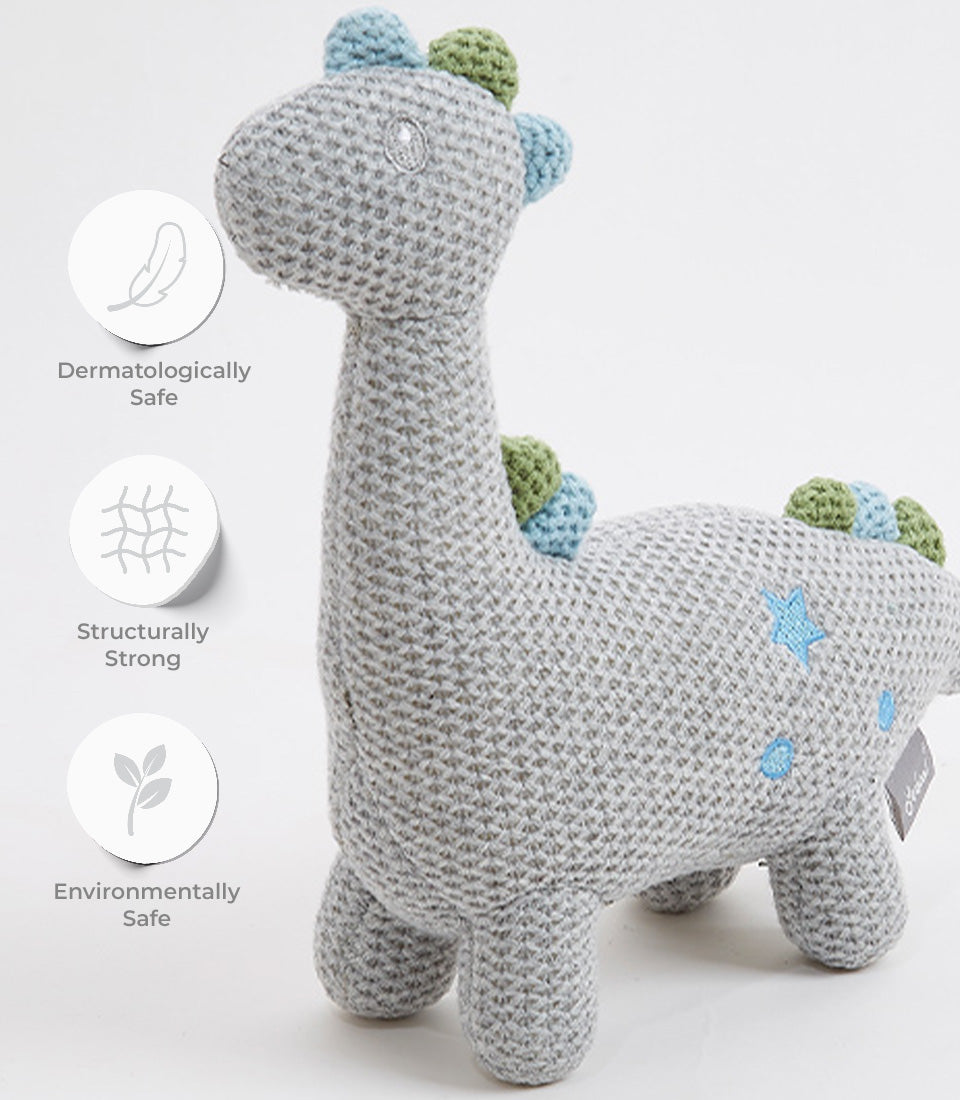 Handcrafted crocheted grey dinosaur plush with blue and green spikes, embroidered stars, dermatologically safe for babies