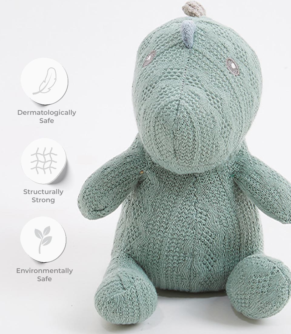 Sage green crocheted dinosaur soft toy with embroidered details, dermatologically safe for babies and children