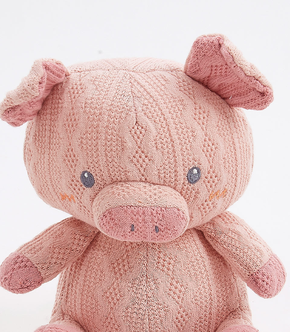 Soft pink handcrafted crocheted pig plush toy with embroidered details and floppy ears
