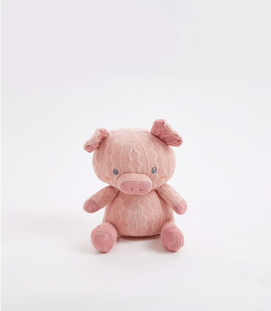 Handcrafted crocheted pink pig soft toy with cable knit pattern and blue eyes, ideal for babies and kids
