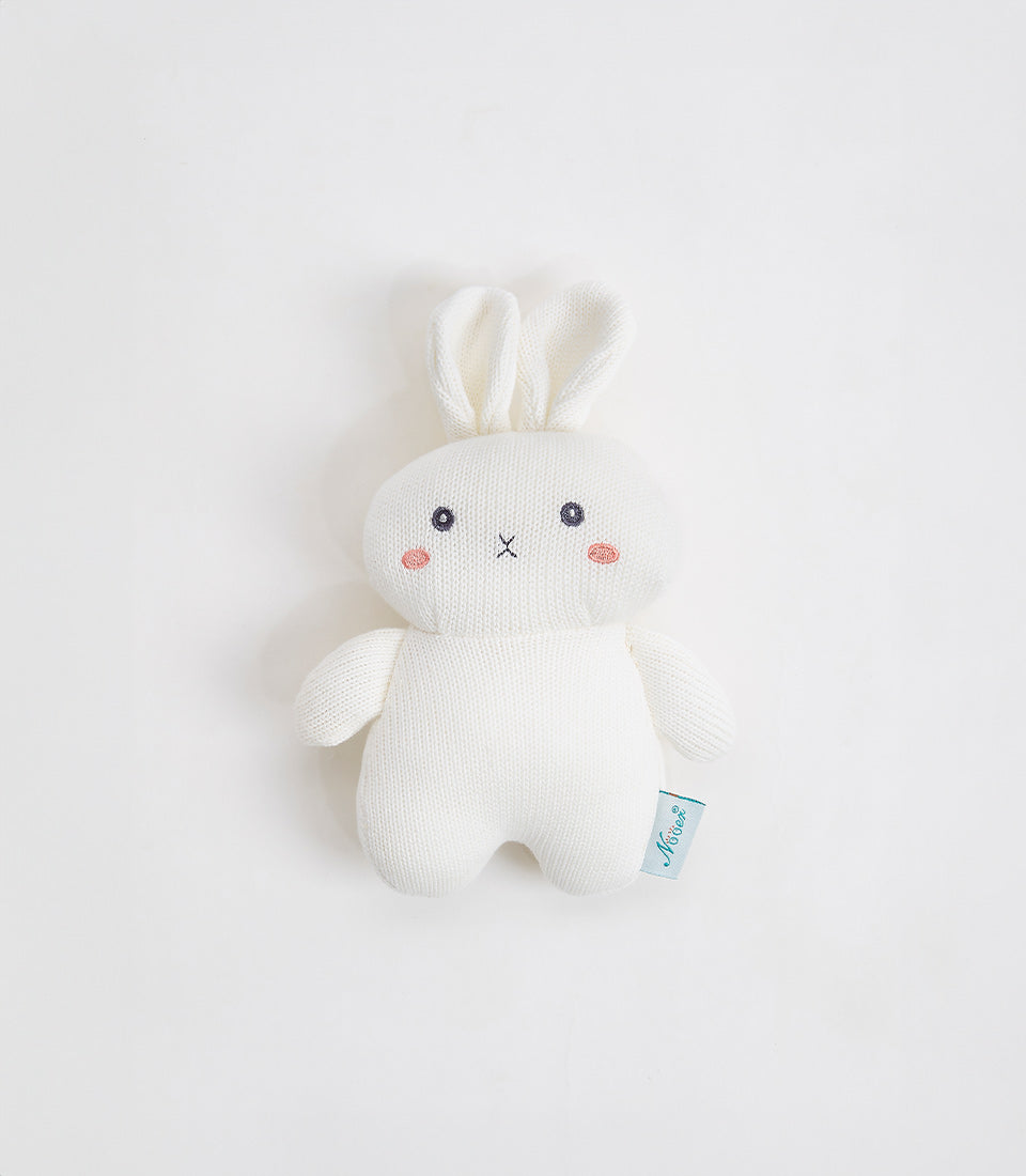 Soft white knitted rabbit plush toy with embroidered face and pink cheeks, perfect for babies and children