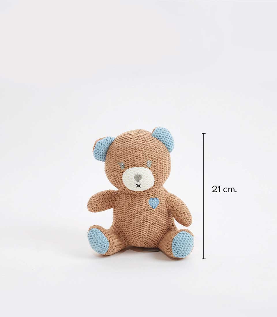 Handcrafted crocheted teddy bear in soft brown with blue accents and embroidered heart