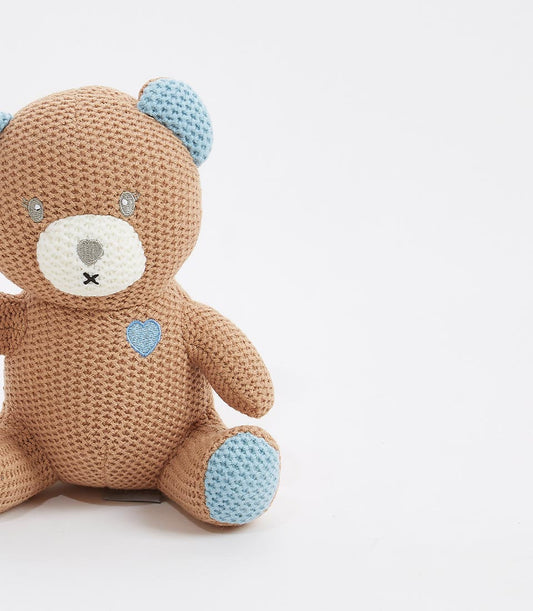 Handcrafted brown and blue crocheted teddy bear with embroidered heart detail, perfect for newborns and children
