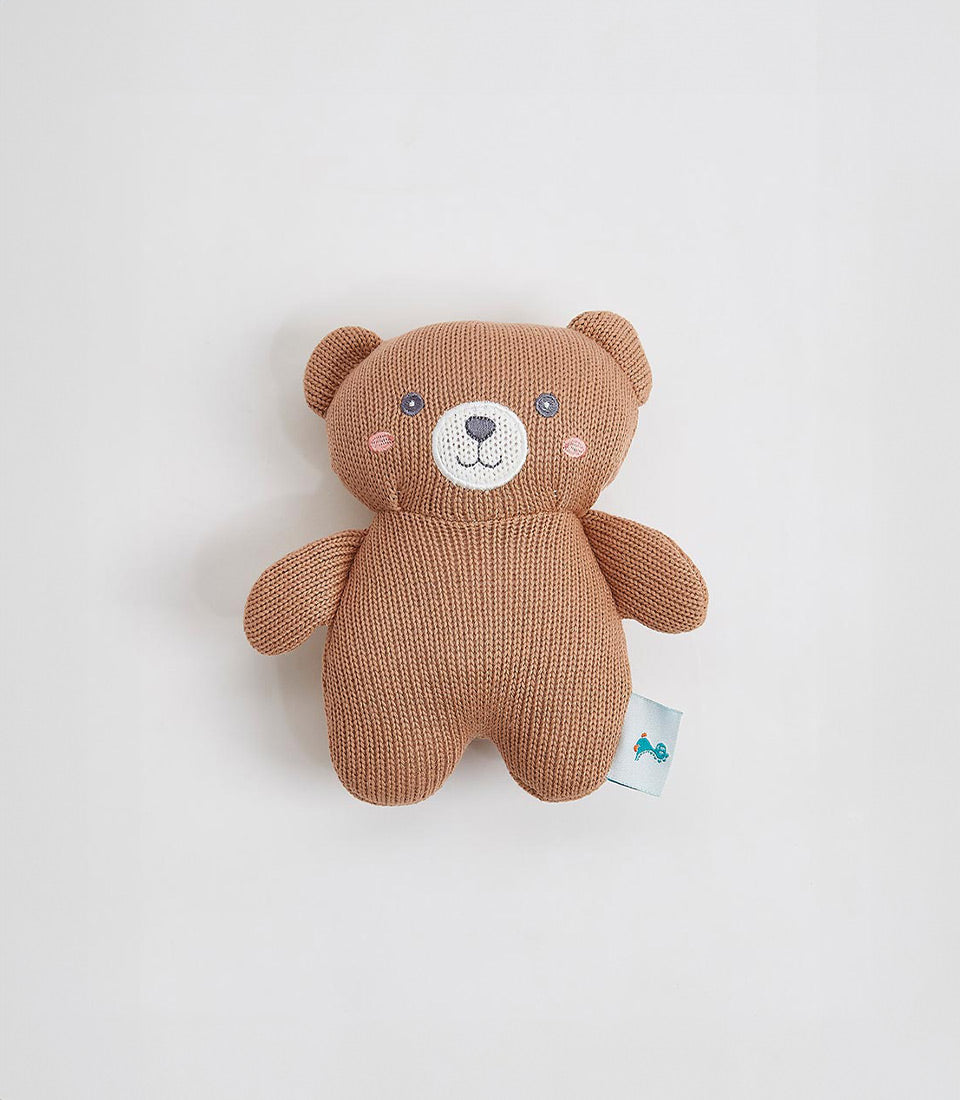 Knitted brown teddy bear with embroidered face and soft plush texture, perfect for babies and young children