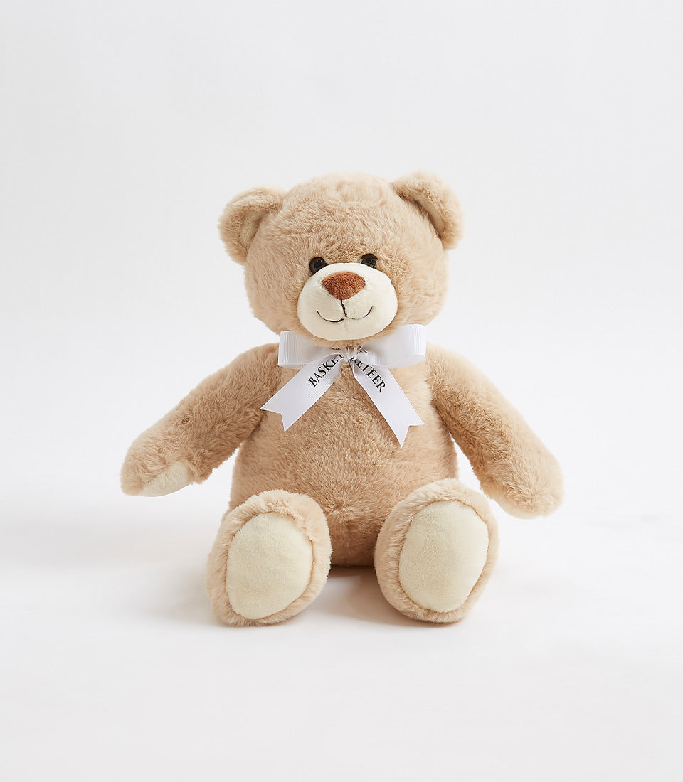 Soft brown plush teddy bear with cream paw pads and white satin bow for gifting