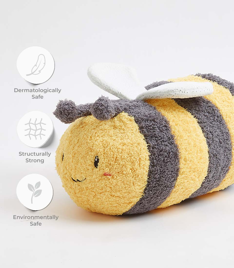 Soft plush bumblebee toy with yellow and grey stripes, white glittery wings, and embroidered smile face