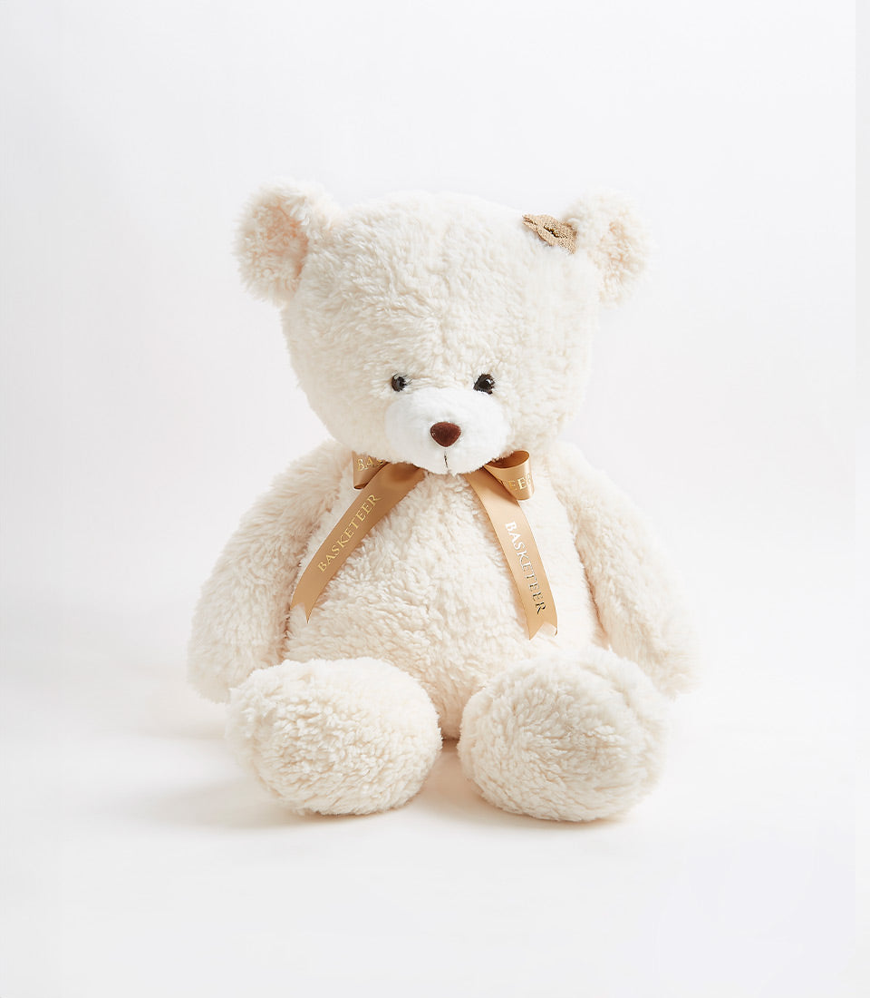 Soft cream teddy bear with satin ribbon bow for children and gift giving