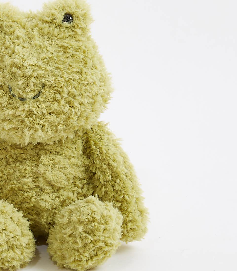Soft green plush frog toy with shaggy fabric and embroidered smile for babies and kids