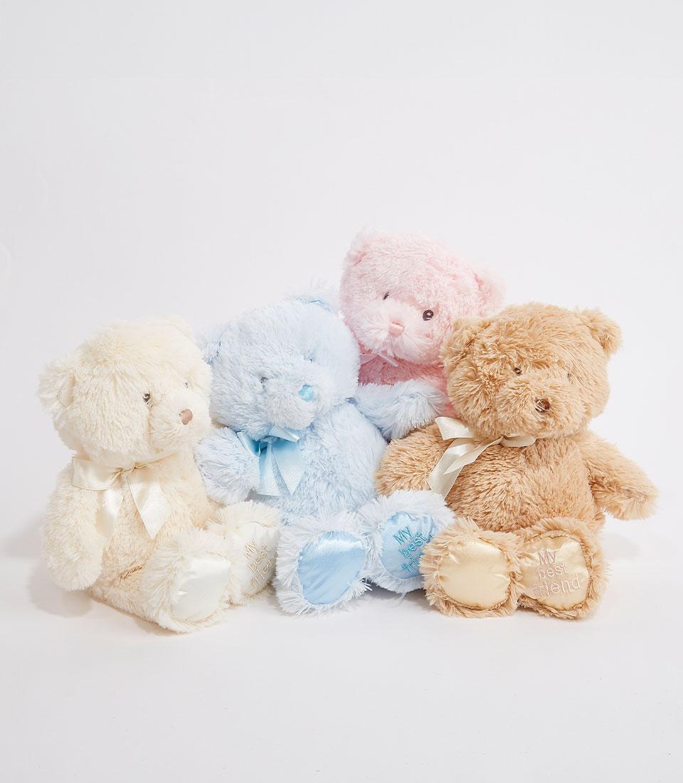 Four pastel plush teddy bears with satin ribbon bows in cream, blue, pink, and light brown