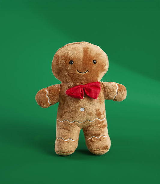 Plush gingerbread man Christmas toy with embroidered smile and red bow tie