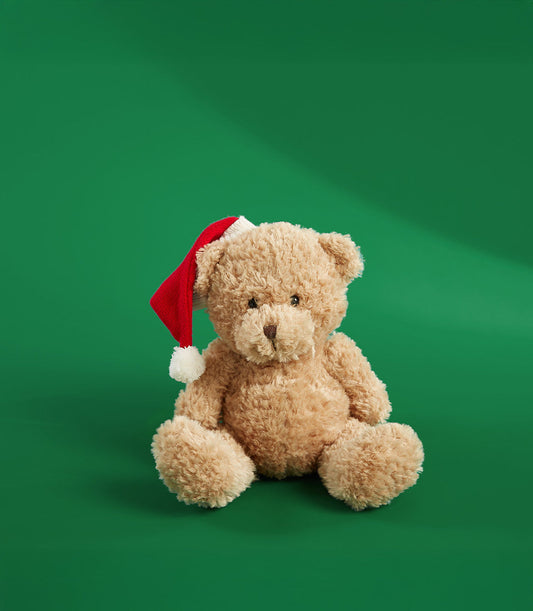 Light brown fluffy teddy bear wearing red and white Santa hat, festive gift add-on
