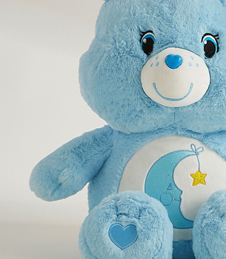 Cozy Dream blue plush bear with embroidered moon belly design and heart details