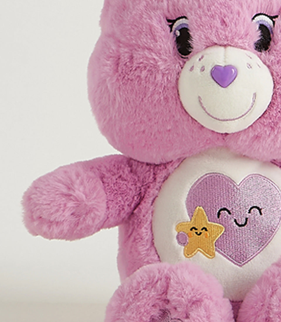 Soft purple plush bear with embroidered heart belly badge, cuddly gift for all ages