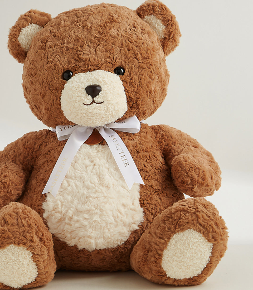 Large plush teddy bear with cream belly and satin ribbon bow, premium gift hamper addition