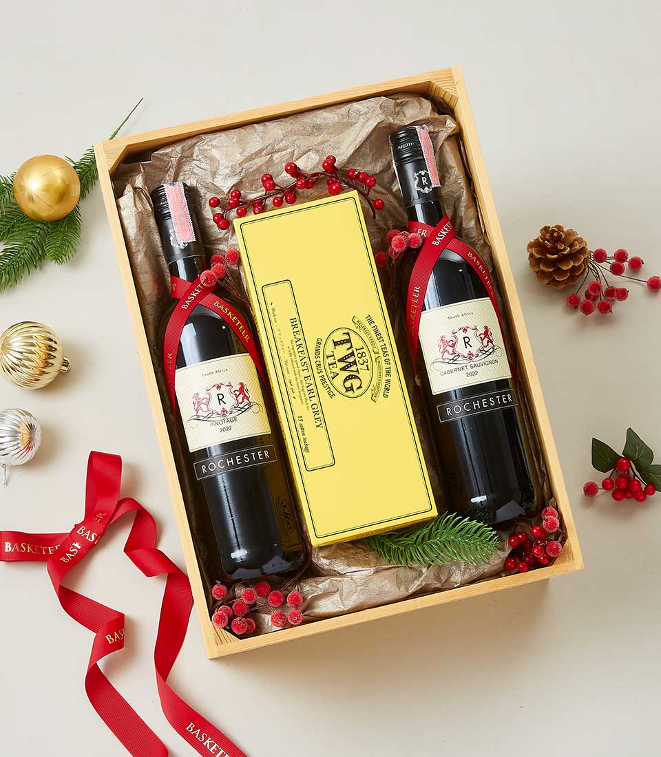 Premium Rochester red wine and TWG tea gift set in wooden crate with festive red ribbon and holiday greenery