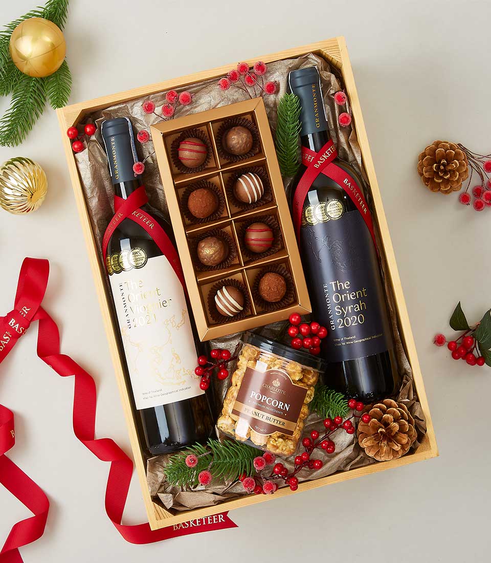 Red and white wine gift box with gourmet chocolates and peanut butter popcorn, festive holiday hamper