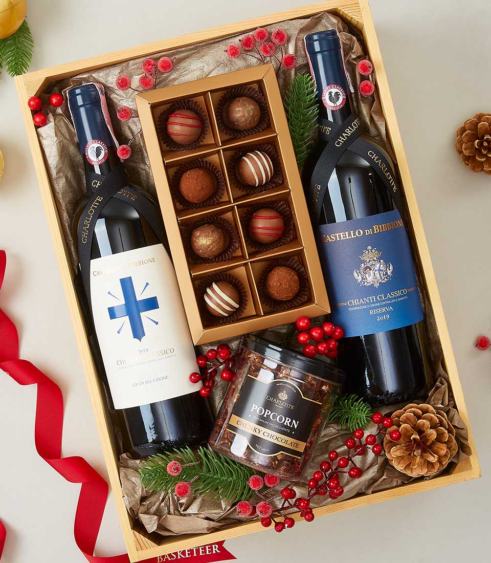 Chianti and Chardonnay luxury gift box with red wines, chocolate truffles, and gourmet popcorn in festive wooden crate