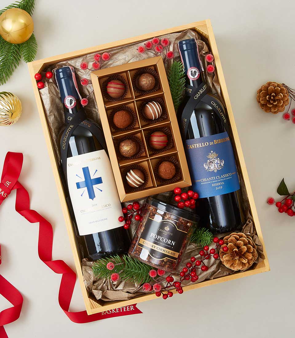 Luxury wine gift box with Chianti Classico, Chardonnay, gourmet chocolates, and chocolate popcorn in wooden crate