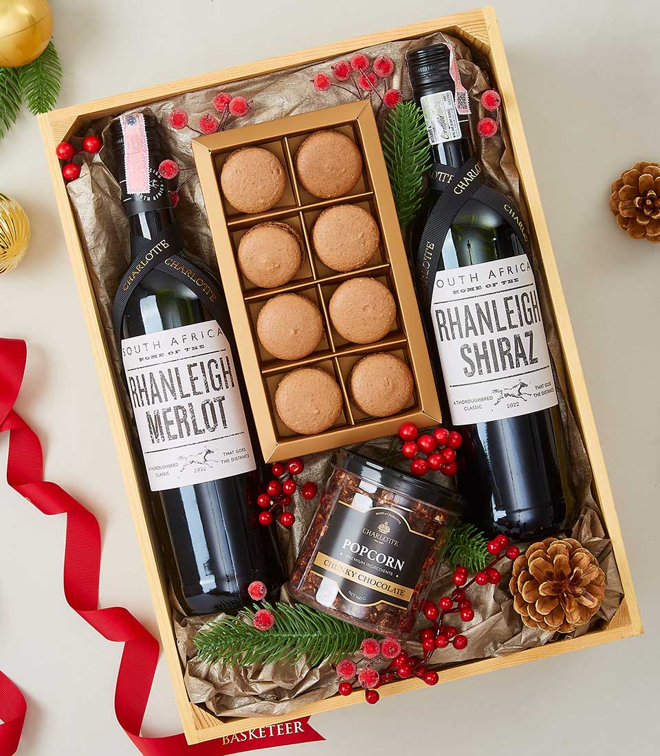 Premium wine gift set with South African Merlot and Shiraz, macarons, and chocolate popcorn in wooden crate