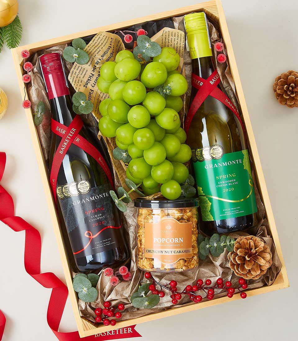 Premium wine and fresh grape gourmet hamper with red and white wines in wooden crate