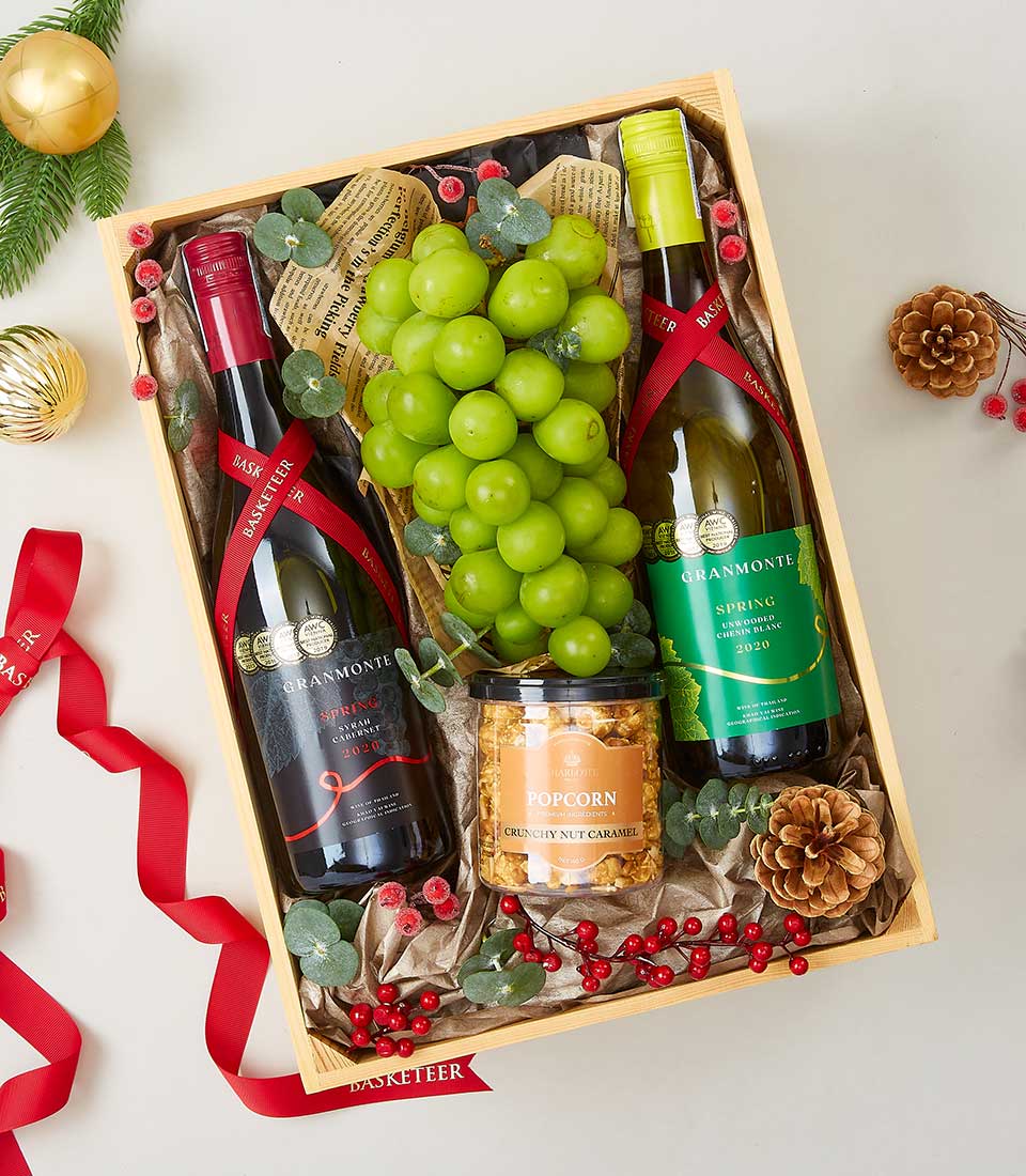 Premium wine and fresh grape gourmet hamper with red and white wines, festive green grapes, and artisan touches