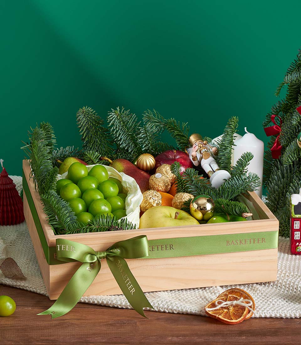 Wooden luxury gift box with fresh fruits, Ferrero Rocher chocolates, and festive pine for Christmas