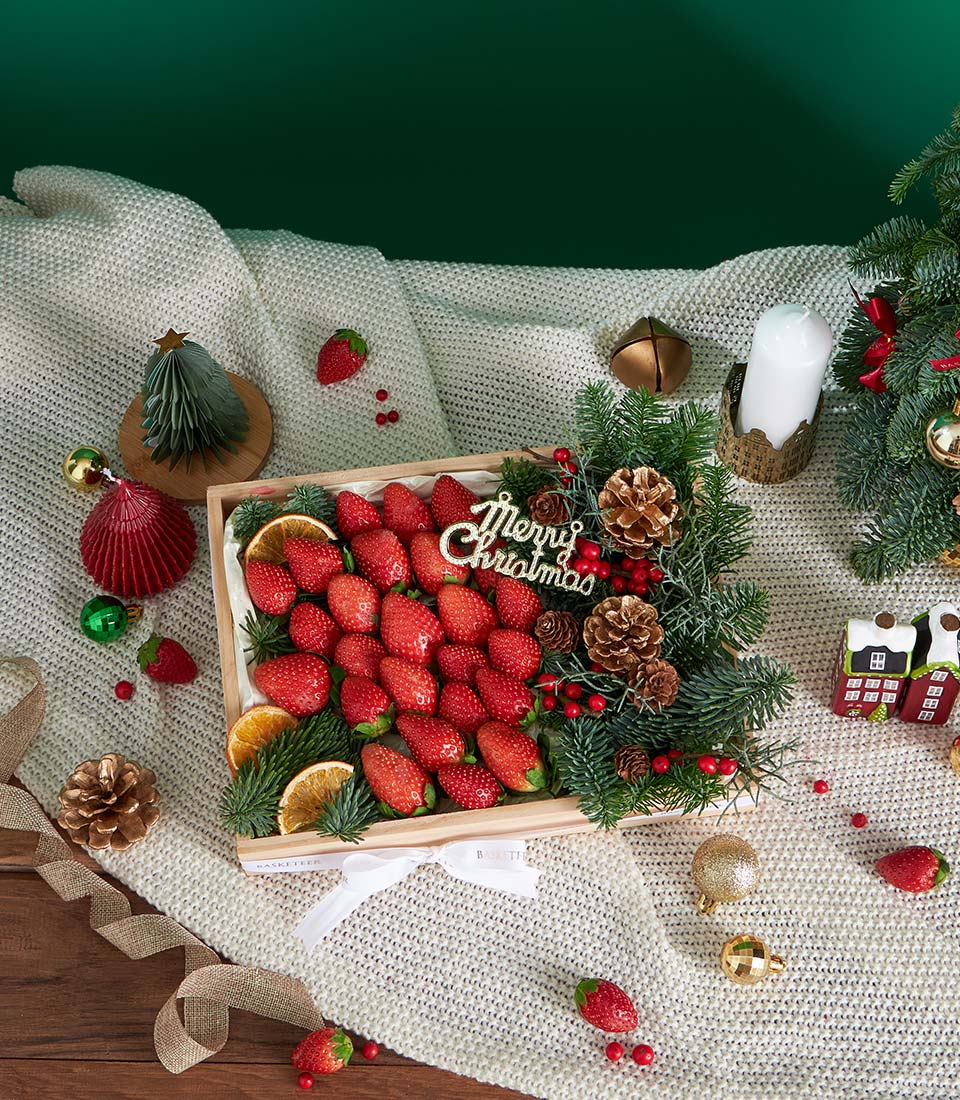 Premium fresh strawberries Christmas gift box with festive greenery and white ribbon, artisan curated fruit hamper