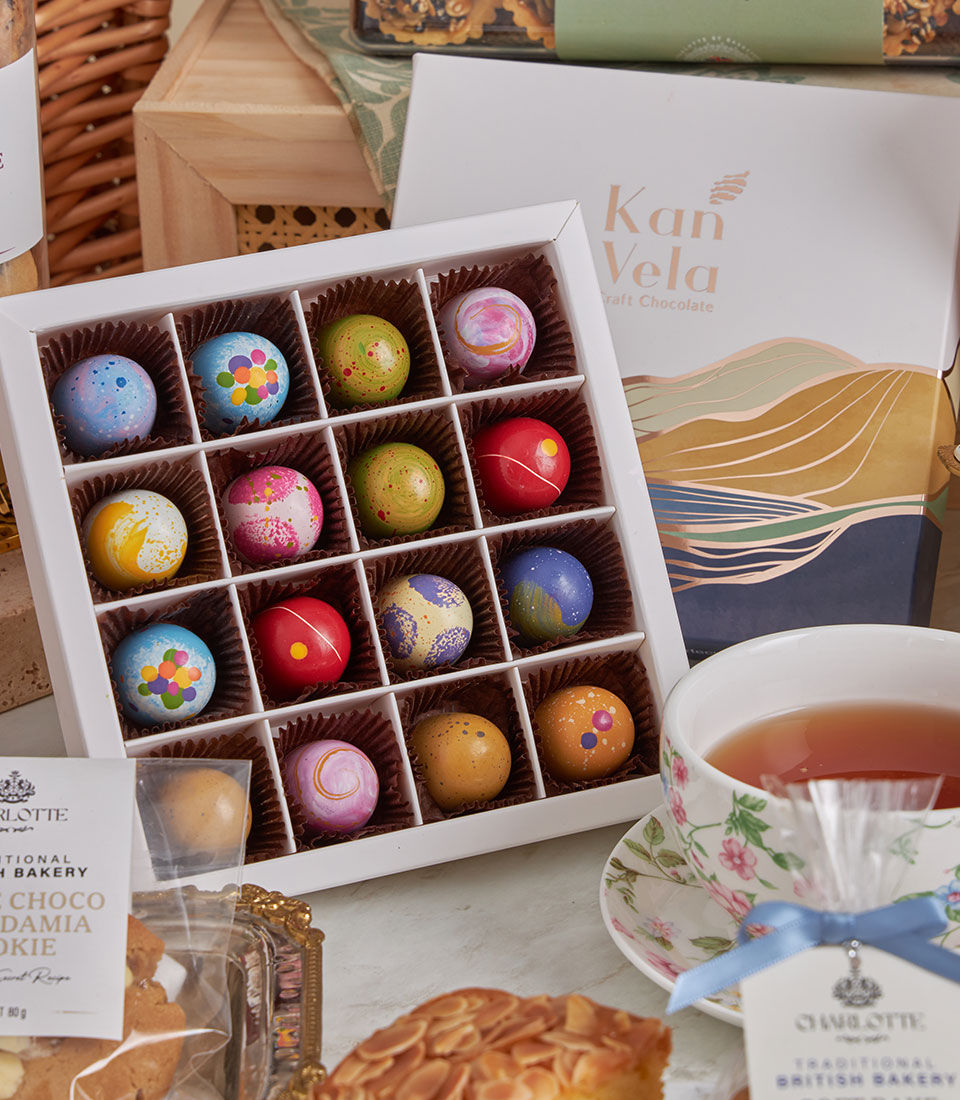 Luxury New Year gift basket with artisan chocolates, premium tea, almond cake, and gourmet treats in white packaging