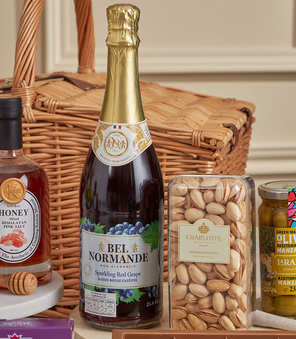 Prestige luxury gourmet gift set with honey, sparkling grape juice, pistachios, and olives in wicker basket