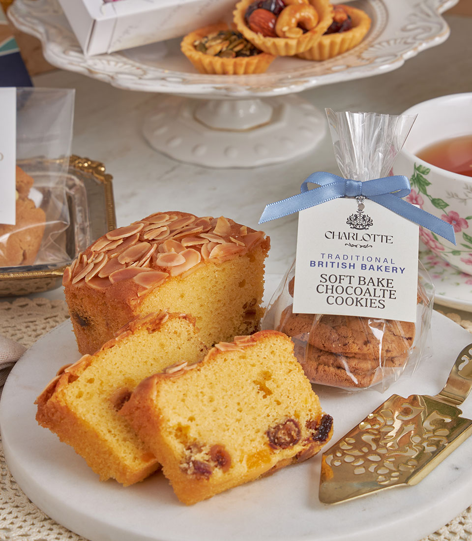 Deluxe teatime gift set with almond cake, fruit cake, British chocolate cookies, and artisan tarts for New Year celebrations