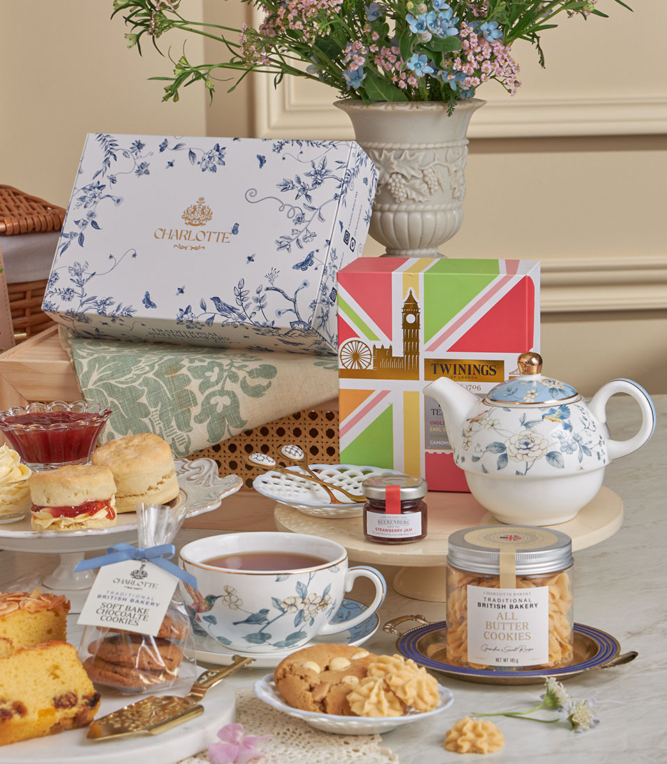 Luxury afternoon tea gift set with Charlotte bakery scones, Twinings tea, and blue floral teapot for New Year celebrations
