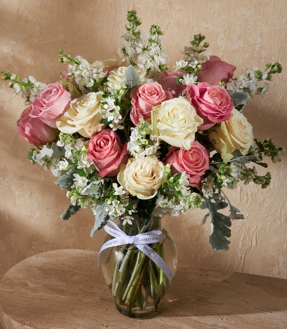 Elegant vase arrangement from Flowers by Basketeer featuring pink and ivory roses, delicate white blooms, and lush greenery. Perfect for flower delivery Bangkok.
