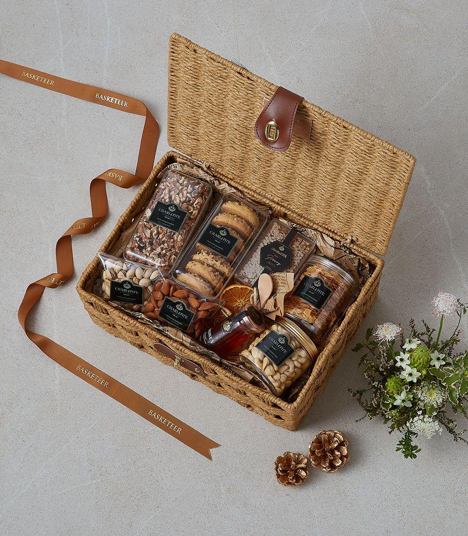 Warm Wishes gourmet gift basket with pecans, almonds, cookies, and honey in woven wicker with leather strap