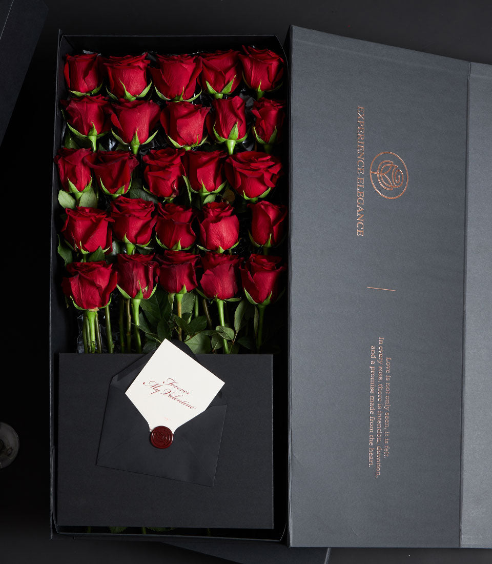 Premium red rose luxury gift box with 28 long-stemmed Ecuador roses, black VIP packaging, and Valentine's Day message card