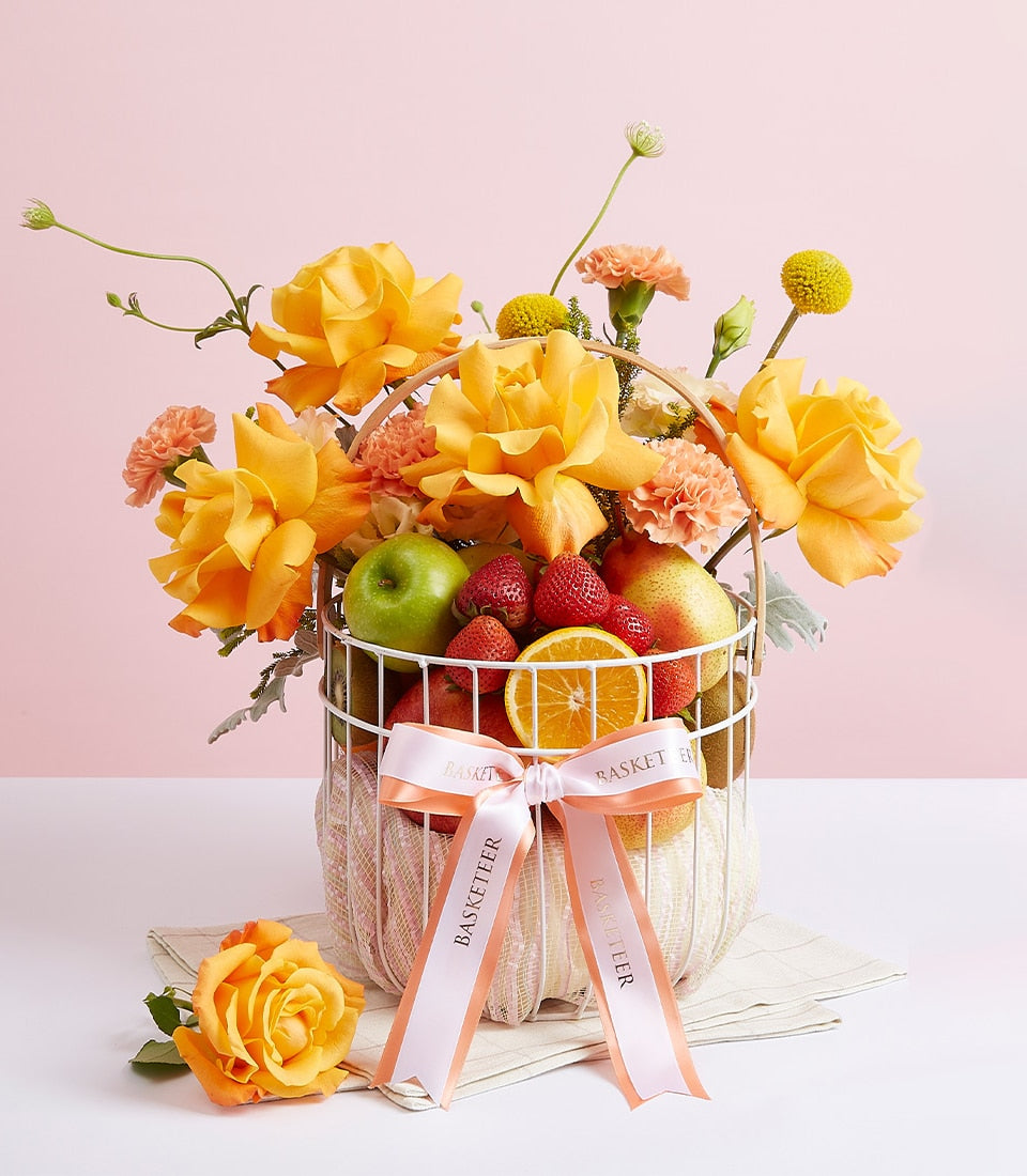 Luxury fresh fruit basket with yellow-orange roses, strawberries, apple, and pear for gifting