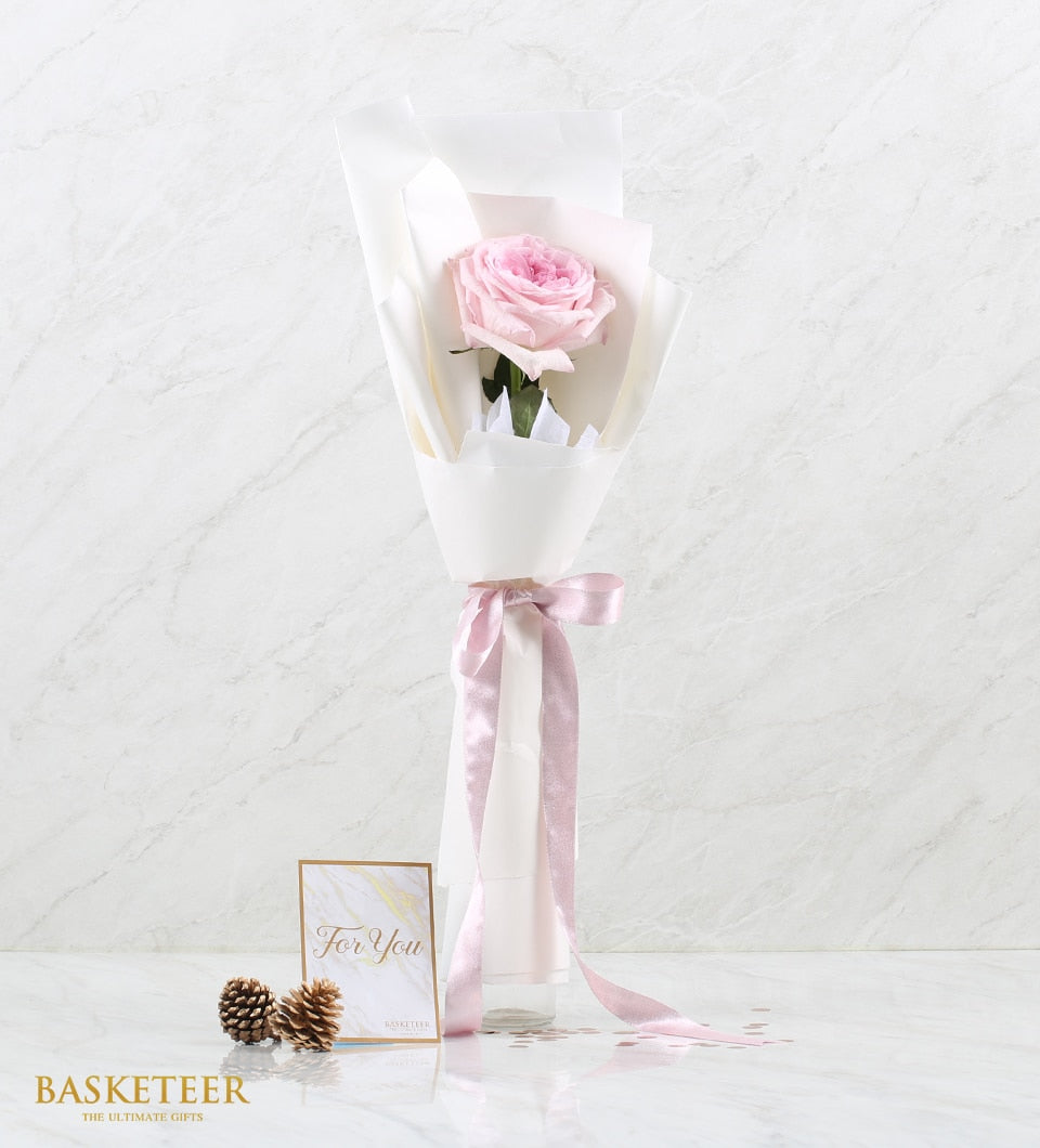 Single pink O'Hara rose with white wrapping, satin ribbon, and For You card