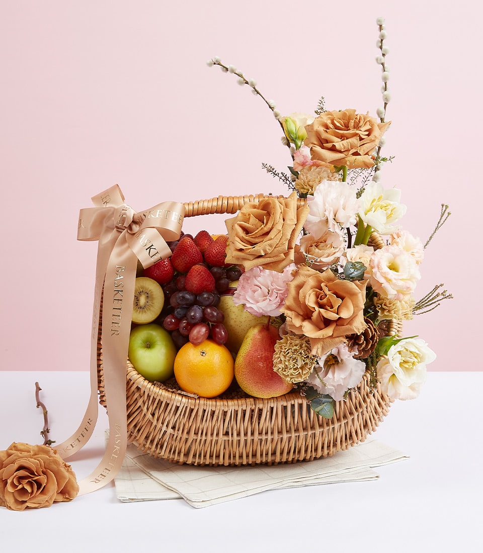 Premium fresh fruit basket with strawberries, kiwi, grapes and peach flowers for birthday celebrations