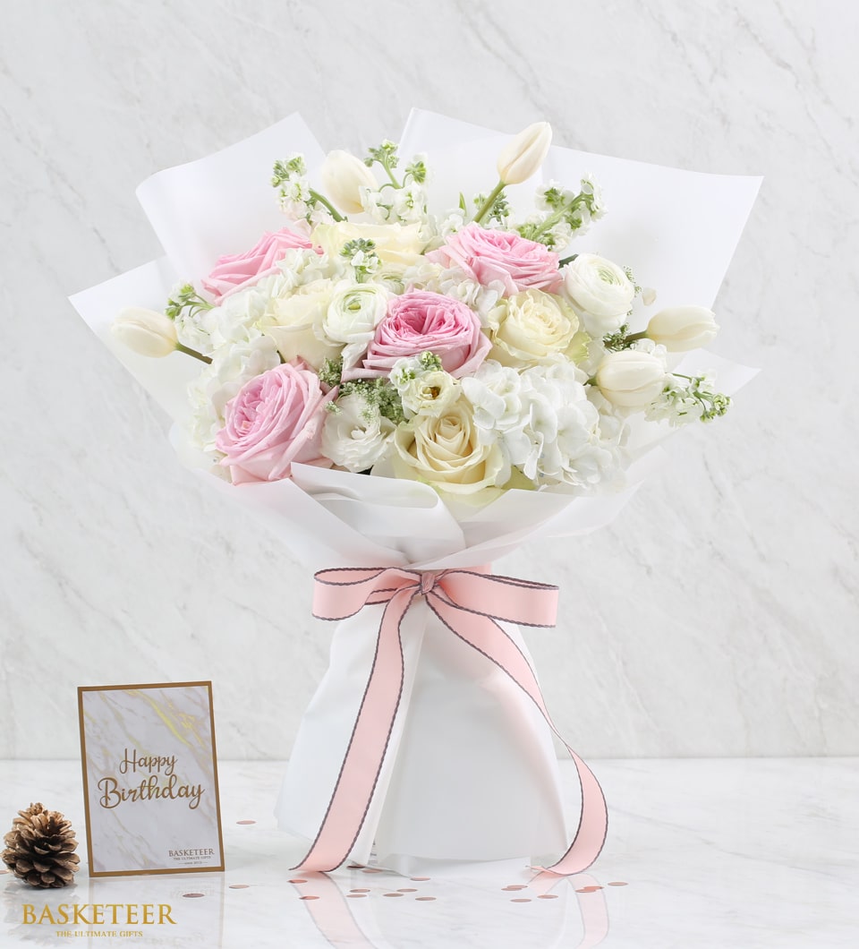 Blush pink roses and white ranunculus bouquet with pink ribbon for Valentine's Day