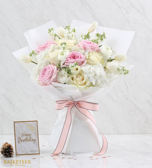 Blush pink roses and white ranunculus bouquet with pink ribbon for Valentine's Day
