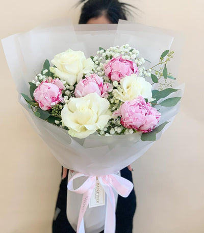 Fresh peony and white rose graduation bouquet with pink ribbon