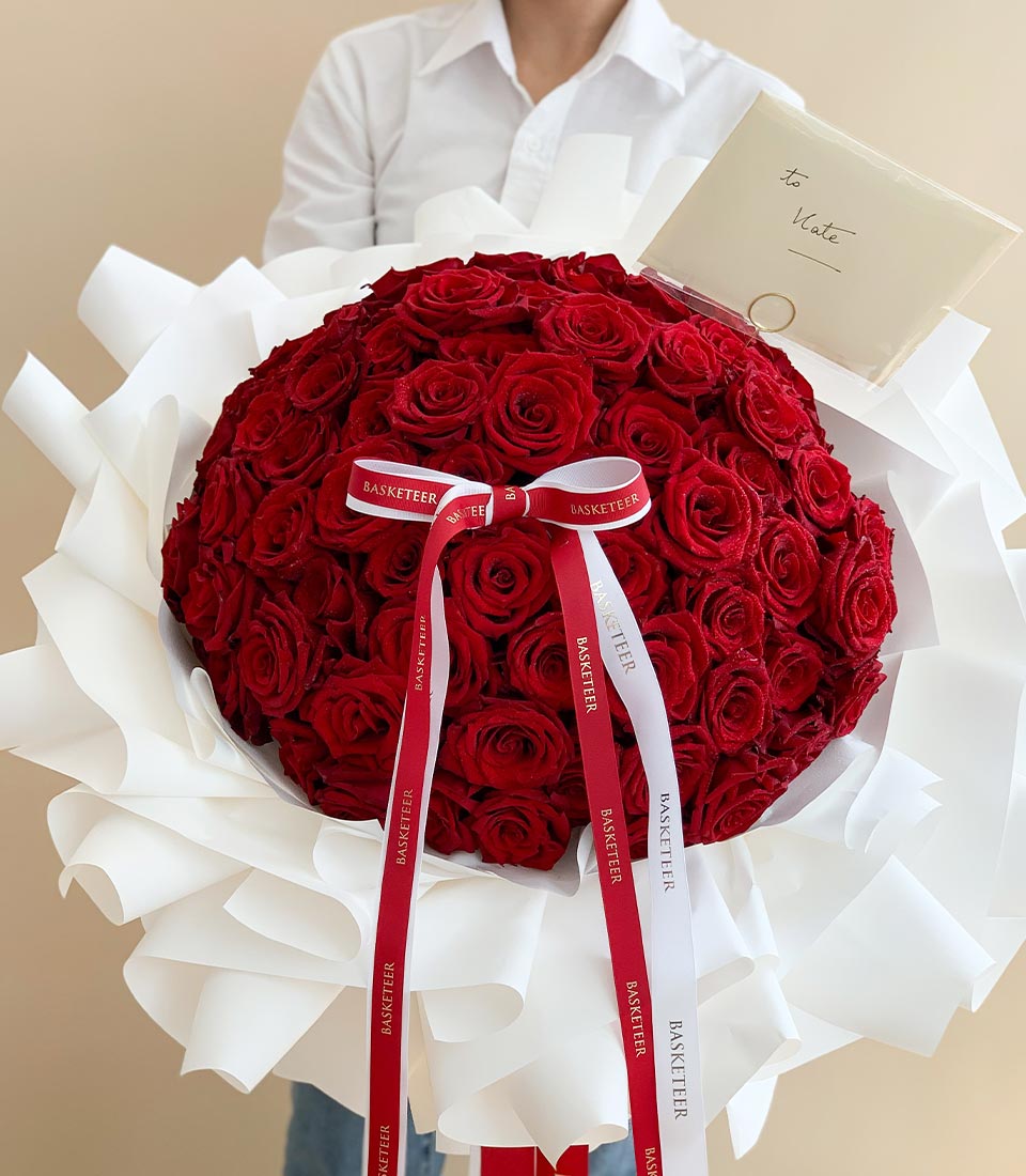 Luxurious red roses bouquet with white ruffled wrap and personalized gift card for anniversary or romantic occasions