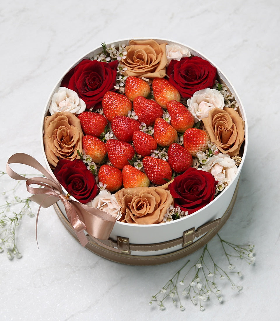 Fresh strawberries and garden roses in luxe white gift box with satin ribbon
