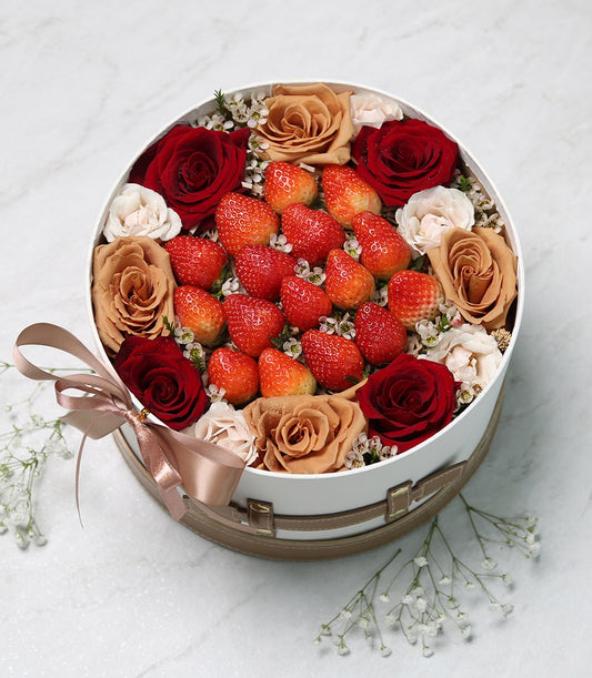Fresh strawberries and garden roses in luxe white gift box with satin ribbon