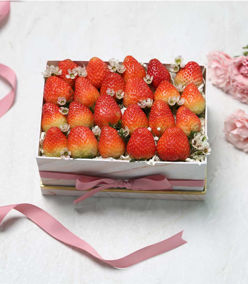 White marble gift box of fresh strawberries with pink satin ribbon, luxury fruit hamper for gifting