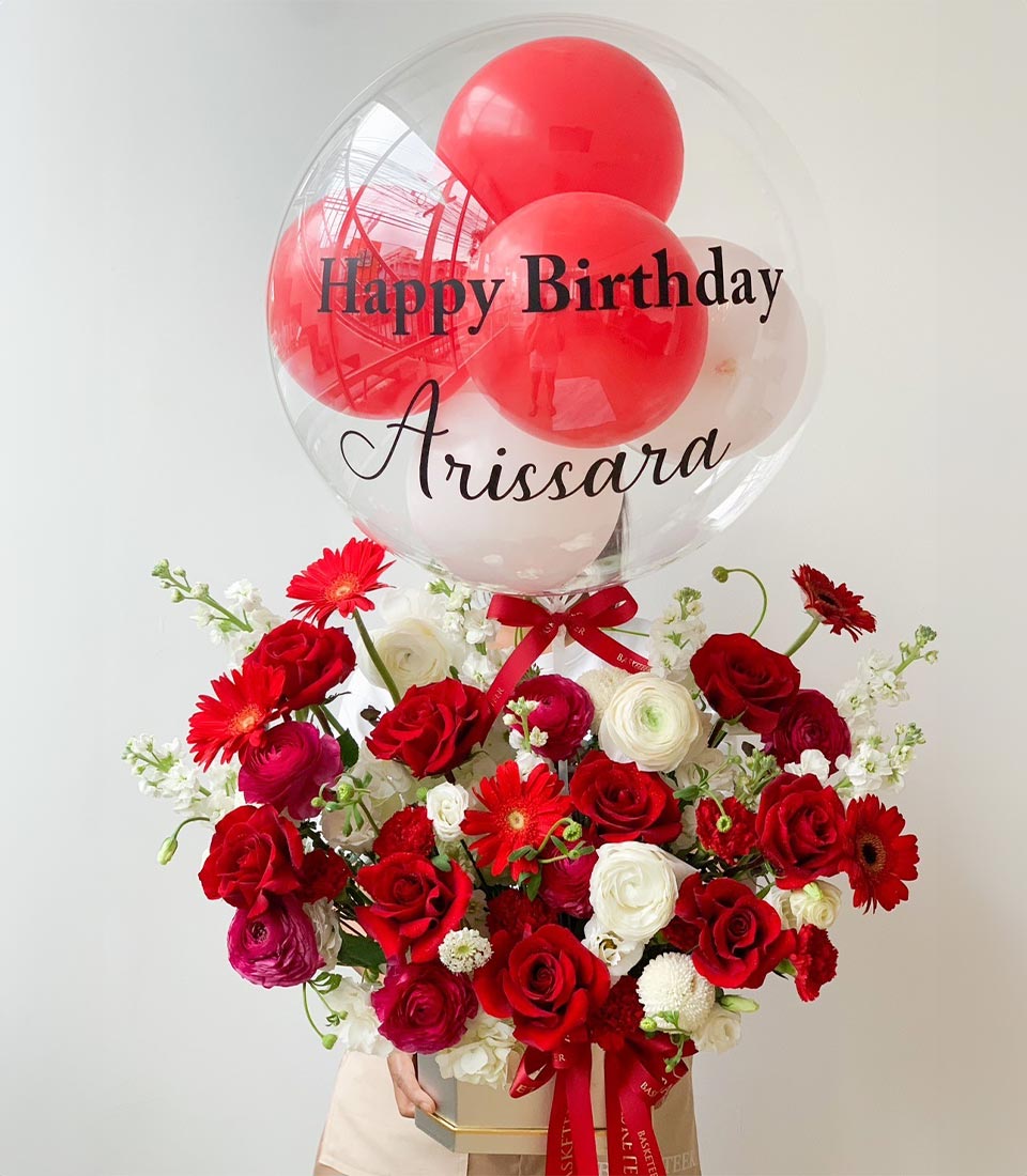 Red and white roses with ranunculus in cream box, topped with personalised bubble balloon for birthday