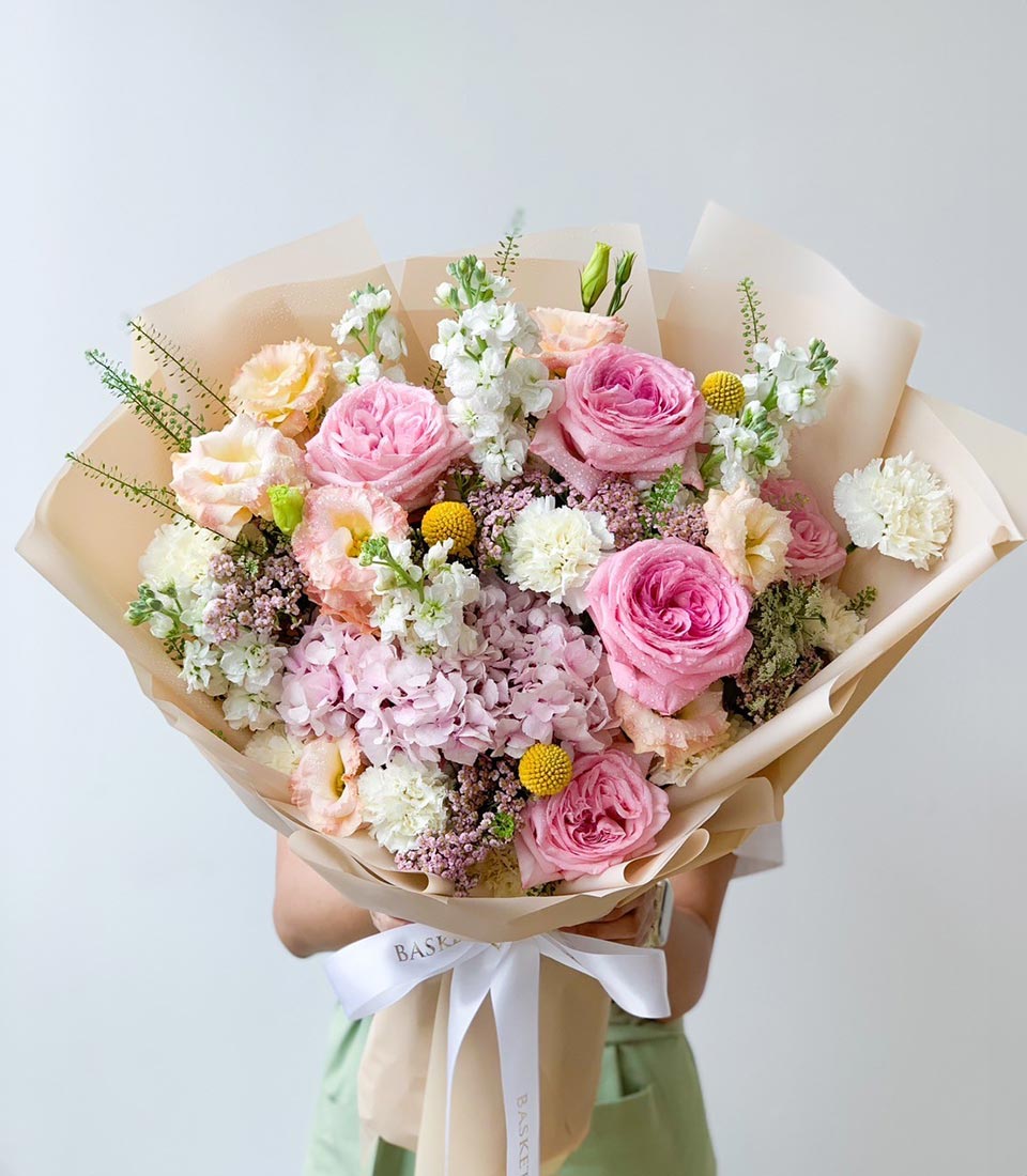 Premium mixed rose and hydrangea bouquet in pink, white, and peach with satin ribbon bow